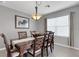 Formal dining room with elegant chandelier, dark wood table and chairs, and natural light at 5111 11Th E St, Bradenton, FL 34203