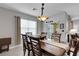 Dining room with gray walls, a chandelier, and a sliding glass door to an outdoor space at 5111 11Th E St, Bradenton, FL 34203