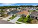 A house and its landscaped front yard with a well-maintained driveway are shown on a sunny day, surrounded by other homes at 5111 11Th E St, Bradenton, FL 34203