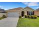 Charming single-story home featuring a well-maintained lawn and attached two-car garage at 5111 11Th E St, Bradenton, FL 34203