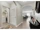 Hallway with laundry room to the left and views of the open kitchen and living area at 5111 11Th E St, Bradenton, FL 34203
