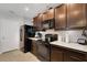 Well-equipped kitchen featuring sleek black appliances, granite countertops, and rich, dark wood cabinetry at 5111 11Th E St, Bradenton, FL 34203
