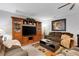 Spacious living room featuring a large wooden entertainment center and comfortable seating arrangement at 5111 11Th E St, Bradenton, FL 34203
