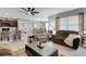Open living space with a ceiling fan, neutral tile flooring, and modern furniture arrangement at 5111 11Th E St, Bradenton, FL 34203