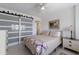 Bedroom features a queen bed, a modern sliding door and ample natural light at 5200 Gulf Dr # 408, Holmes Beach, FL 34217