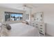 Bright bedroom featuring a queen bed, dresser, window, and ceiling fan at 5200 Gulf Dr # 408, Holmes Beach, FL 34217