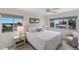 Inviting bedroom features a plush queen bed, neutral tones, and bright natural light at 5200 Gulf Dr # 408, Holmes Beach, FL 34217