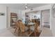 Dining area featuring a glass-topped table, seating for six, and a view of the kitchen at 5200 Gulf Dr # 408, Holmes Beach, FL 34217
