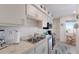 Compact kitchen with stainless appliances, tile backsplash and ocean view breakfast nook at 5200 Gulf Dr # 408, Holmes Beach, FL 34217