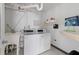 Clean laundry room with modern machines and convenient shelving for supplies at 5200 Gulf Dr # 408, Holmes Beach, FL 34217