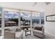 Bright living space with comfortable seating and expansive windows showcasing beautiful beach view at 5200 Gulf Dr # 408, Holmes Beach, FL 34217