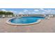 A kidney-shaped outdoor pool surrounded by lounge chairs and a brick patio overlooking the ocean at 5200 Gulf Dr # 408, Holmes Beach, FL 34217