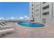 Poolside with lounge chairs, ocean view, and sunny skies create a relaxing atmosphere at 5200 Gulf Dr # 408, Holmes Beach, FL 34217