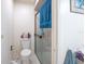 Bathroom featuring a toilet and glass shower with a blue towel hanging on the door at 523 Spring Lakes Blvd, Bradenton, FL 34210