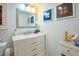Bathroom featuring a white vanity with a marble countertop and a large mirror at 523 Spring Lakes Blvd, Bradenton, FL 34210