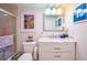 Bathroom featuring a white vanity with a marble countertop, a mirror, and a toilet at 523 Spring Lakes Blvd, Bradenton, FL 34210
