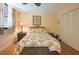 Comfortable bedroom featuring a queen sized bed, ceiling fan, and bedside tables with lamps at 523 Spring Lakes Blvd, Bradenton, FL 34210