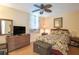 Bedroom featuring a bed with floral bedding, wooden floors, and a wooden dresser at 523 Spring Lakes Blvd, Bradenton, FL 34210