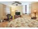Bedroom featuring floral bedspread, wicker chair, and TV on dresser at 523 Spring Lakes Blvd, Bradenton, FL 34210