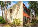 Exterior view of a two-story home with a stucco facade, wood accents, and mature trees at 523 Spring Lakes Blvd, Bradenton, FL 34210