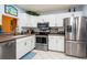 Bright kitchen with stainless steel appliances and white cabinets at 523 Spring Lakes Blvd, Bradenton, FL 34210