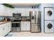 Updated kitchen featuring stainless steel appliances, white cabinets, and tiled floors at 523 Spring Lakes Blvd, Bradenton, FL 34210