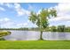 Scenic view of the lake from the grassy lawn on a partly cloudy day at 523 Spring Lakes Blvd, Bradenton, FL 34210