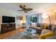 Comfortable living room with sliding glass doors to patio and ceiling fan at 523 Spring Lakes Blvd, Bradenton, FL 34210