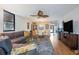 Spacious living room with view of dining area, modern fan and access to patio at 523 Spring Lakes Blvd, Bradenton, FL 34210
