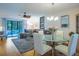 Open-concept living and dining area featuring contemporary furnishings and access to outdoor patio at 523 Spring Lakes Blvd, Bradenton, FL 34210
