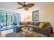 Comfortable living room with sliding glass doors to patio and ceiling fan at 523 Spring Lakes Blvd, Bradenton, FL 34210
