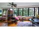 Sun-drenched living room with hardwood floors, comfortable seating, and large windows at 523 Spring Lakes Blvd, Bradenton, FL 34210