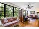 Comfortable living room area with hardwood floors, ceiling fan, and large windows with a view at 523 Spring Lakes Blvd, Bradenton, FL 34210