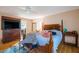 Cozy bedroom with wooden bed frame, hardwood floors, and lots of natural light at 523 Spring Lakes Blvd, Bradenton, FL 34210