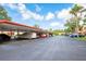 Carport area with parking spaces and multiple vehicles, located near the residences at 523 Spring Lakes Blvd, Bradenton, FL 34210