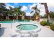 Outdoor pool area with lounge chairs and a hot tub, surrounded by lush greenery at 523 Spring Lakes Blvd, Bradenton, FL 34210