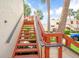 Outdoor condo staircase with wooden railings and lush greenery at 523 Spring Lakes Blvd, Bradenton, FL 34210