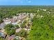 Wide aerial view shows the home nestled amongst mature trees and established landscaping at 5623 Wilde Oak Way, Sarasota, FL 34232