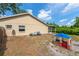 Large backyard features a screen enclosed patio, playhouse, and mature landscaping at 5623 Wilde Oak Way, Sarasota, FL 34232
