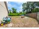 Spacious backyard features a playhouse, plenty of room for play, and a wood privacy fence at 5623 Wilde Oak Way, Sarasota, FL 34232