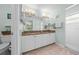 Bathroom featuring double sinks, granite countertops, a shower and tile flooring at 5623 Wilde Oak Way, Sarasota, FL 34232