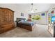 Vaulted ceiling bedroom featuring a bed with storage, a ceiling fan, and an antique-looking wardrobe at 5623 Wilde Oak Way, Sarasota, FL 34232