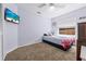 Bedroom featuring a ceiling fan, a flat screen television, and a window view at 5623 Wilde Oak Way, Sarasota, FL 34232