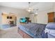 Bedroom leading to an outdoor patio, a ceiling fan, and neutral carpeting at 5623 Wilde Oak Way, Sarasota, FL 34232