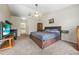Spacious bedroom featuring a ceiling fan, a bed with storage, and an ensuite bathroom at 5623 Wilde Oak Way, Sarasota, FL 34232