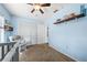 bedroom featuring a ceiling fan, closet doors, and light blue walls at 5623 Wilde Oak Way, Sarasota, FL 34232