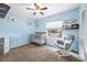 Bedroom showcasing light blue walls, a ceiling fan, and a gray rocking chair at 5623 Wilde Oak Way, Sarasota, FL 34232