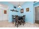 Cozy dining area with a wooden table, four chairs, and light blue walls at 5623 Wilde Oak Way, Sarasota, FL 34232