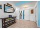 Open foyer featuring tiled floors, a console table, decorative mirror, and closet for storage at 5623 Wilde Oak Way, Sarasota, FL 34232