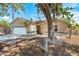 Charming one-story home featuring an attached garage, mature landscaping, and a welcoming front porch at 5623 Wilde Oak Way, Sarasota, FL 34232